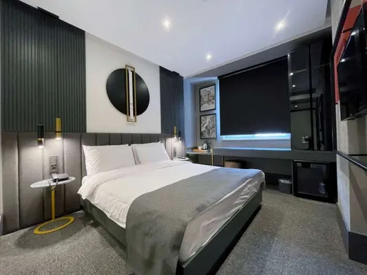 Double bed and study desk in the Standard Room
