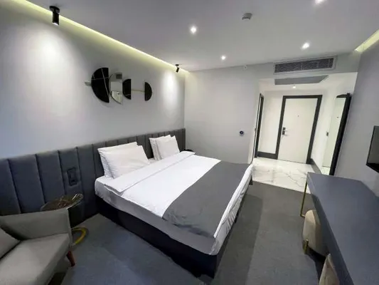 Bed and armchair in the Standard Room
