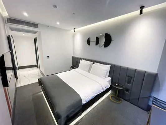 Bed and wall-mounted television in the Standard Room