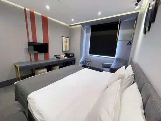 Wide view of the bed and study desk in the Standard Room