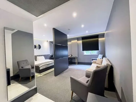 King Suite sitting area and full-length mirror