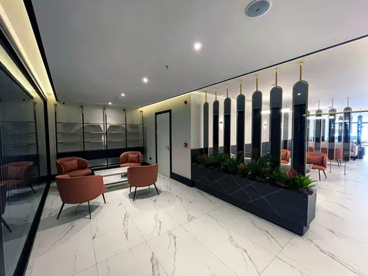 Lobby seating area with orange armchairs