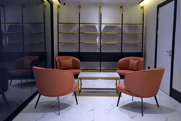 Orange armchairs and a coffee table in the lobby