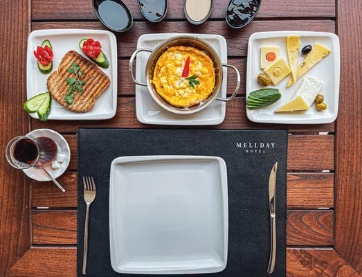Buffet breakfast plate: omelet, cheese and olives